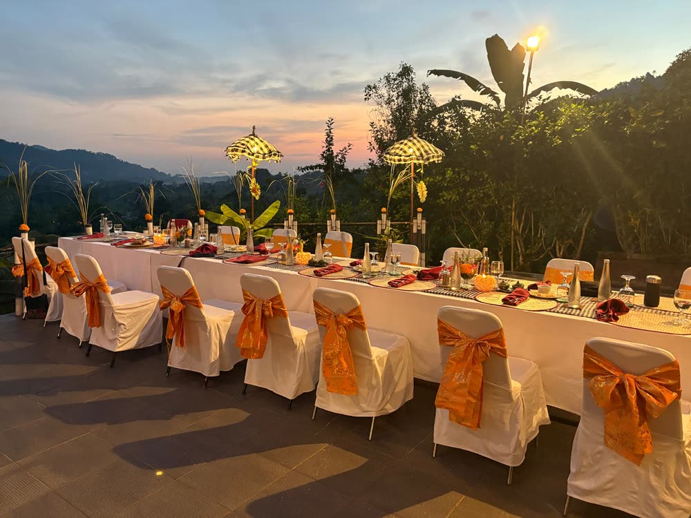 The dinner table laid on the terrace at sunset, overlooking the Sidemen valley