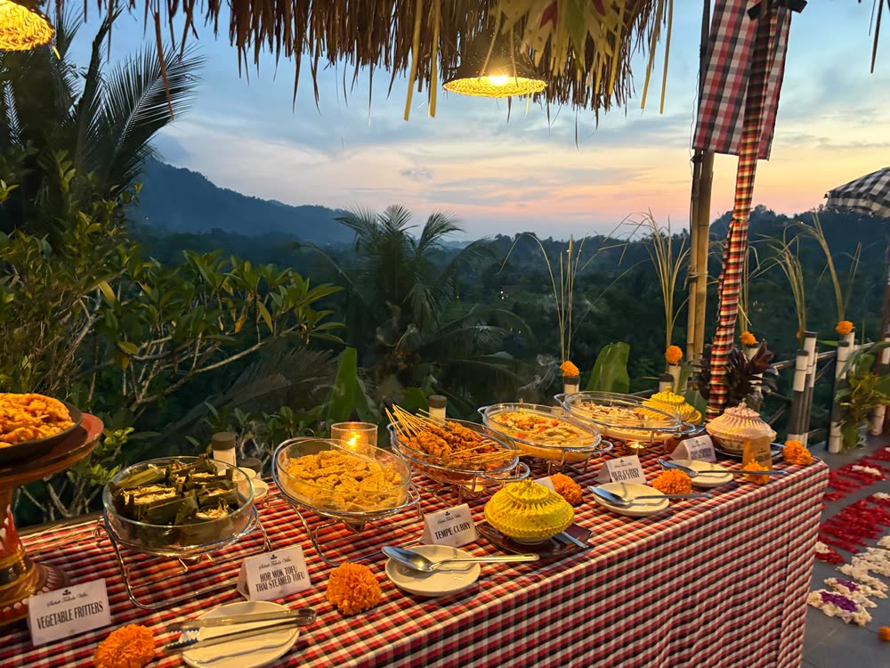 Evening buffet of organic vegetarian Balinese dishes laid out above the valley
